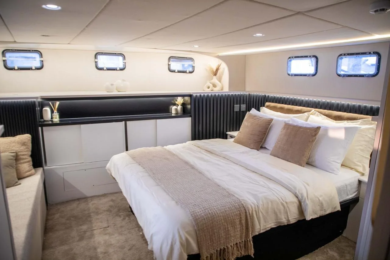 Master cabin with a king bed and portholes