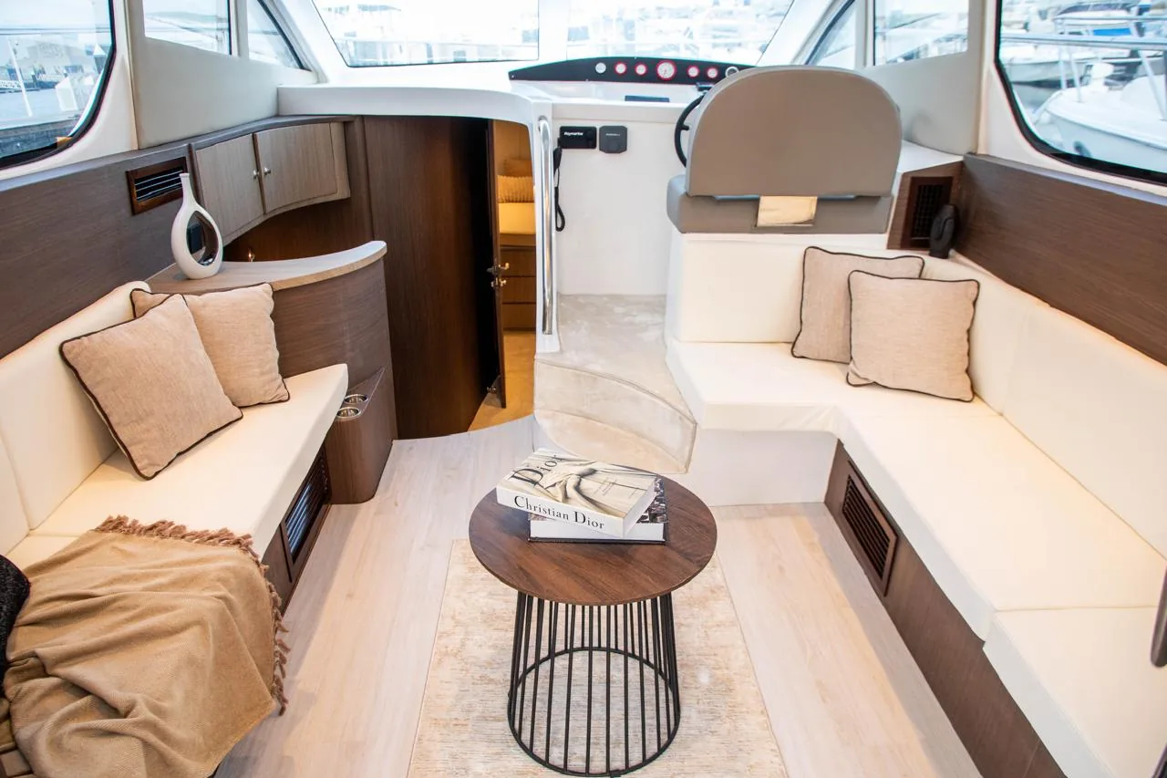 Sunlit yacht salon with cream seating