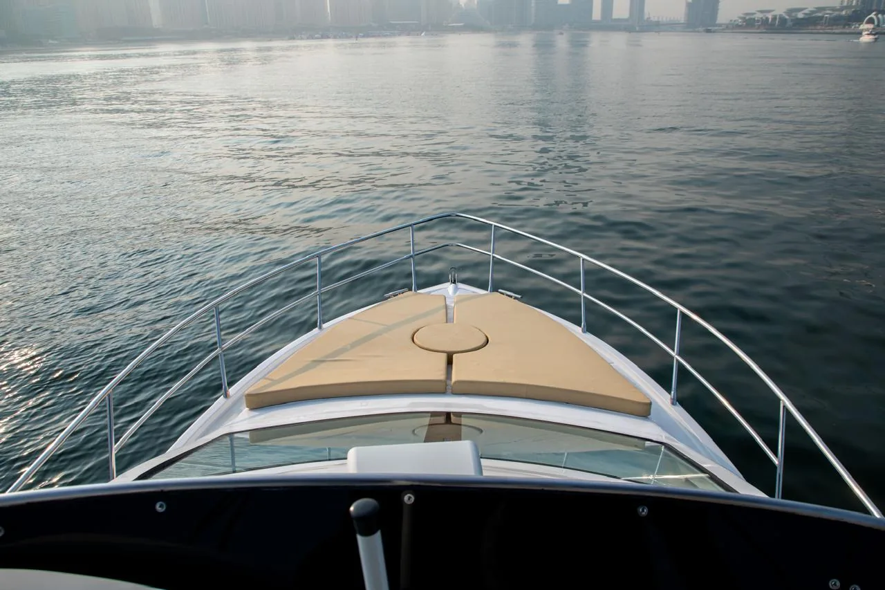 Foredeck sun pad at golden hour in the marina