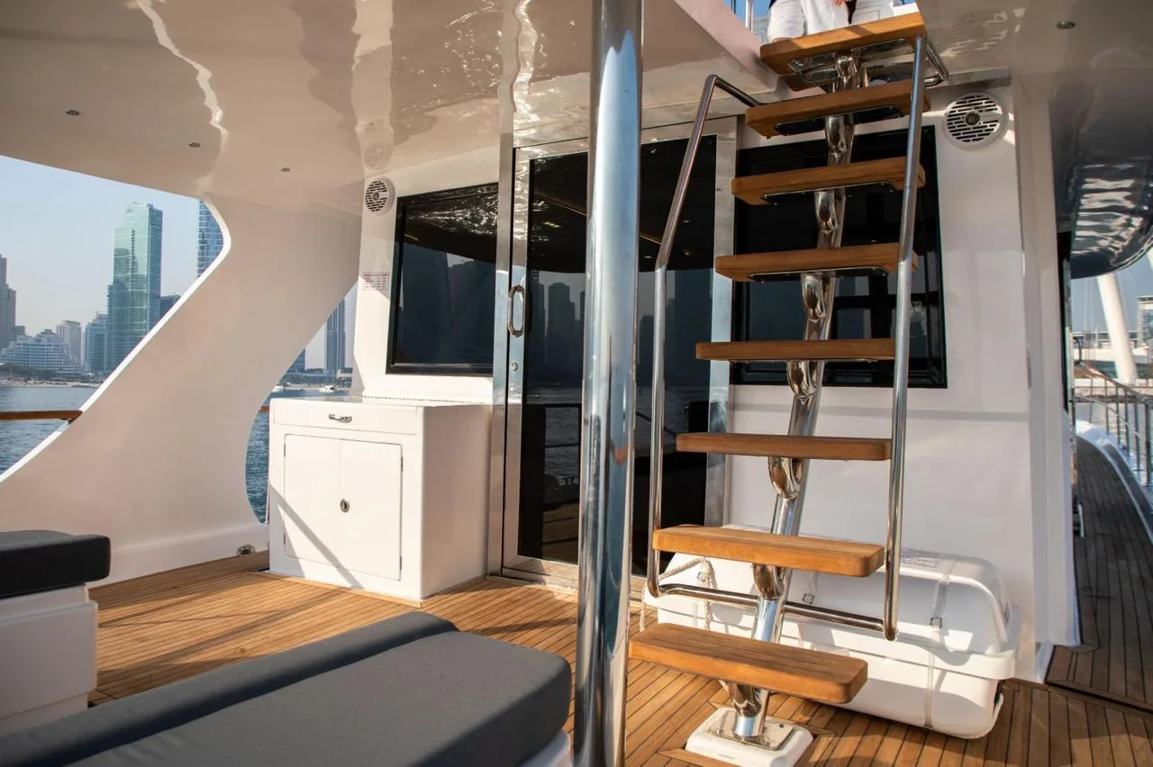 Polished teak-and-steel staircase to the flybridge